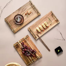 Load image into Gallery viewer, Wooden Serving Tray by Allthingscurated is designed with versatility and organic beauty in mind. Crafted from natural wood and accented with gold hardware handles for easy transportation and handling, these wooden trays serve up your sliced breads, cheeses and drinks in style. With 3 size options, they are ideal for hosting and a nice presentation with a natural touch to your table.