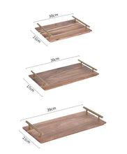 Load image into Gallery viewer, Wooden Serving Tray by Allthingscurated is designed with versatility and organic beauty in mind. Crafted from natural wood and accented with gold hardware handles for easy transportation and handling, these wooden trays serve up your sliced breads, cheeses and drinks in style. With 3 size options, they are ideal for hosting and a nice presentation with a natural touch to your table.