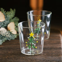 Load image into Gallery viewer, Christmas Tree Drinking Glass by Allthingscurated has a playful and whimsical design, featuring a sculptural 3D Christmas Tree within the tumbler. The tree comes in a 2 colors, green and white. Measuring 8.5cm or 3.3 inches in width at the top, 9cm or 3.5 inches in height and 6.5cm or 2.5 inches in width at the base, the drinking glass has a capacity of 300ml or 10 ounce.