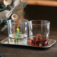 Load image into Gallery viewer, Christmas Tree Drinking Glass by Allthingscurated has a playful and whimsical design, featuring a sculptural 3D Christmas Tree within the tumbler. The tree comes in a 2 colors, green and white. Measuring 8.5cm or 3.3 inches in width at the top, 9cm or 3.5 inches in height and 6.5cm or 2.5 inches in width at the base, the drinking glass has a capacity of 300ml or 10 ounce.