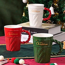 Load image into Gallery viewer, Snow Capped Christmas Gift Mug by Allthingscurated boasts festive colors of red, green and white, featuring a Merry Christmas greeting engraved on the mug. The elegant mug is crafted from ceramic with a snow-like lid and a charming Christmas relief pattern, making it the perfect gift for your friends and colleagues during office parties. Comes with a straw for added convenience.