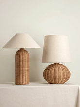 Load image into Gallery viewer, Two rattan table lamps with beige lampshades on a light surface. The Yumi Japanese Table Lamp by Allthingscurated embraces the wabi-sabi philosophy that profound beauty emerges from simplicity. Crafted from natural rattan, its minimalist design feels both rustic and contemporary. It elevates your home décor by transforming any space into a sanctuary of quiet sophistication.