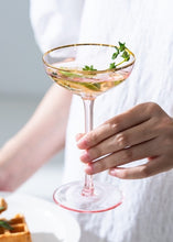 Load image into Gallery viewer, Allthingscurated Alaia Pink gold-rimmed champagne Coupe with a capacity of 140ml or 4.7 fluid ounce. Made of lead-free crystal glass