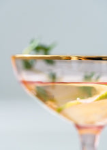 Load image into Gallery viewer, Allthingscurated Alaia Pink gold-rimmed champagne Coupe with a capacity of 140ml or 4.7 fluid ounce. Made of lead-free crystal glass
