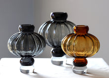 Load image into Gallery viewer, Luna Lantern Vases by Allthingscurated are stylish and versatile. Crafted from high-quality thick glass and creatively shaped like an Oriental Lantern with a strong aesthetic, they are perfect for creative floral arrangement or simply as a decorative display on its own. Comes in 2 sizes and 3 avaliable colors of green, gray and amber.
