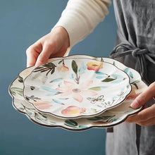 Load image into Gallery viewer, Allthingscurated’s Camille dinnerware features hand-painted florals, fauna and pretty butterflies and a color scheme of pink, yellow, blue,green and brown against a white ceramic background. Every plate is designed with a brown-lined scallop edge. Available in 6, 8 and 10 inches or 15.5, 20 and 25.5cm.