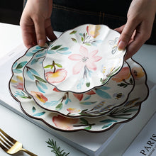 Load image into Gallery viewer, Allthingscurated’s Camille dinnerware features hand-painted florals, fauna and pretty butterflies and a color scheme of pink, yellow, blue,green and brown against a white ceramic background. Every plate is designed with a brown-lined scallop edge. Available in 6, 8 and 10 inches or 15.5, 20 and 25.5cm.