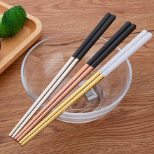 Load image into Gallery viewer, These Chinese chopsticks by Allthingscurated is contemporary with a square design for better food gripping. Made of 304 food grade stainless steel, they come in 6 different color combinations of Black and Gold, Black and Rose Gold, Black and Silver, White and Black, White and Gold, White and Rose Gold. Retailed as a set of 6 pairs, choose from one of the above color combinations or opt for an assorted set of 6 different color combinations. Chopstick length is 23.5cm or 9 inches.