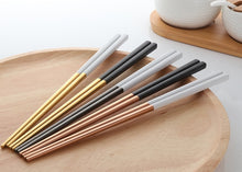 Load image into Gallery viewer, These Chinese chopsticks by Allthingscurated is contemporary with a square design for better food gripping. Made of 304 food grade stainless steel, they come in 6 different color combinations of Black and Gold, Black and Rose Gold, Black and Silver, White and Black, White and Gold, White and Rose Gold. Retailed as a set of 6 pairs, choose from one of the above color combinations or opt for an assorted set of 6 different color combinations. Chopstick length is 23.5cm or 9 inches.