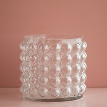 Load image into Gallery viewer, Zayla Bubble Vase by Allthingscurated features a geometric bubble design. The eye-catching detail and design are enough to make it a statement centerpiece with or without floral display. Comes in black or clear and in 2 sizes. The short vase measures 17cm or 6.6 inches in height and 16cm or 6.2 inches in diameter. The tall vase measures 27.5cm or 10.7 inches in height and 13cm or 5 inches in diameter. This is a pair of clear vases with small pink flowers in the tall vase. This is a short clear vase.