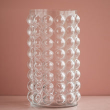 Load image into Gallery viewer, Zayla Bubble Vase by Allthingscurated features a geometric bubble design. The eye-catching detail and design are enough to make it a statement centerpiece with or without floral display. Comes in black or clear and in 2 sizes. The short vase measures 17cm or 6.6 inches in height and 16cm or 6.2 inches in diameter. The tall vase measures 27.5cm or 10.7 inches in height and 13cm or 5 inches in diameter. This is a pair of clear vases with small pink flowers in the tall vase. This is a tall clear vase.