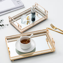 Load image into Gallery viewer, Donatella Mirror tray by Allthingscurated features a mirror surface and intricate gold-gilded pattern surround all sides of the rectangle tray and with 2 handles. Available in small, medium and large size. Featured here are two trays. One tray is with perfume bottles and another tray being used to serve a cup of coffee.