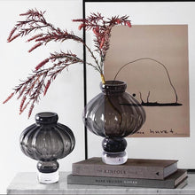 Load image into Gallery viewer, Luna Lantern Vases by Allthingscurated are stylish and versatile. Crafted from high-quality thick glass and creatively shaped like an Oriental Lantern with a strong aesthetic, they are perfect for creative floral arrangement or simply as a decorative display on its own. Comes in 2 sizes and 3 avaliable colors of green, gray and amber.