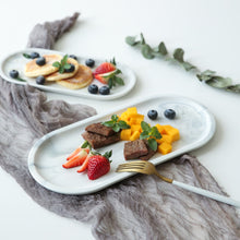 Load image into Gallery viewer, Allthingscurated Marble Design Oval Ceramic Trays in White with subtle marble veining. These trays can be used for serving and decorative purposes. Available in Small and Large size. Large tray measuring 32 by 15 centimeters or 12.5 by 5.9 inches. Small tray measures 25.5 by 11.8 centimeters or 10 by 4.6 inches.