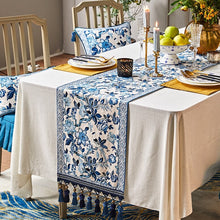 Load image into Gallery viewer, Porcelain Blue Table Runner by Allthingscurated features detailed designs of florals and birds in blue and printed on white background, inspired by the ancient Chinese Porcelain. A fusion of the east and west— this CHINOISERIE style is contemporary, CHARMING and TIMELESS. We added generous tassels in two shades of blues for a striking contrast. Made of cotton-linen blend with 6 sizes available.