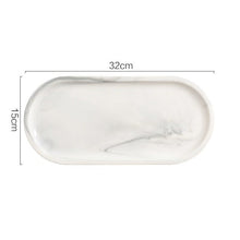 Load image into Gallery viewer, Allthingscurated Marble Design Oval Ceramic Trays in White with subtle marble veining. These trays can be used for serving and decorative purposes. Available in Small and Large size. This large tray measures 32 by 15 centimeters or 12.5 by 5.9 inches.