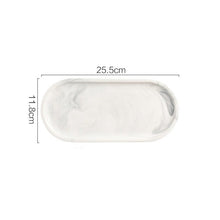 Load image into Gallery viewer, Allthingscurated Marble Design Oval Ceramic Trays in White with subtle marble veining. These trays can be used for serving and decorative purposes. Available in Small and Large size. This small tray measures 25.5 by 11.8 centimeters or 10 by 4.6 inches.