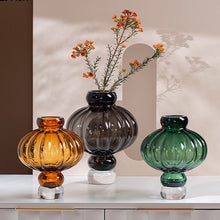 Load image into Gallery viewer, Luna Lantern Vases by Allthingscurated are stylish and versatile. Crafted from high-quality thick glass and creatively shaped like an Oriental Lantern with a strong aesthetic, they are perfect for creative floral arrangement or simply as a decorative display on its own. Comes in 2 sizes and 3 avaliable colors of green, gray and amber.