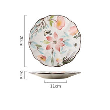 Load image into Gallery viewer, Allthingscurated’s Camille dinnerware features hand-painted florals, fauna and pretty butterflies and a color scheme of pink, yellow, blue,green and brown against a white ceramic background. Every plate is designed with a brown-lined scallop edge. This plate is 8 inches or 20cm.