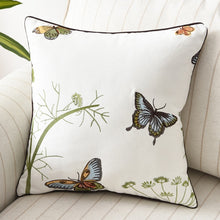 Load image into Gallery viewer, Allthingscurated Spring Harmony Cushion Cover Collection in garden-inspired theme featuring butterflies, florals and birds in embroidering in 100% cotton fabric. Measuring 45 x 45cm or 18 x 18 inches. Available in 7 designs. Shown here Butterflies in blue, brown and yellow Design E.