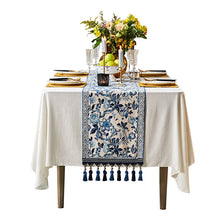 Load image into Gallery viewer, Porcelain Blue Table Runner by Allthingscurated features detailed designs of florals and birds in blue and printed on white background, inspired by the ancient Chinese Porcelain. A fusion of the east and west— this CHINOISERIE style is contemporary, CHARMING and TIMELESS. We added generous tassels in two shades of blues for a striking contrast. Made of cotton-linen blend with 6 sizes available.