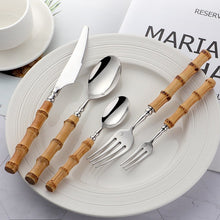 Load image into Gallery viewer, Allthingscurated Natural Bamboo Cutlery Set consisting of 1 dinner knife, 1 dinner spoon, 1 dinner fork, 1 teaspoon and 1 fruit fork. Available in 5-piece set for 1 person, or 20-piece set for 4 persons and 30-piece set for 6 persons. Made of 18/10 stainless steel and natural bamboo for handle.