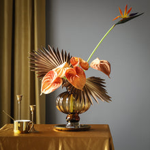 Load image into Gallery viewer, Luna Lantern Vases by Allthingscurated are stylish and versatile. Crafted from high-quality thick glass and creatively shaped like an Oriental Lantern with a strong aesthetic, they are perfect for creative floral arrangement or simply as a decorative display on its own. Comes in 2 sizes and 3 avaliable colors of green, gray and amber.