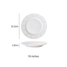 Load image into Gallery viewer, Juliette White Lace Dinnerware by Allthingscurated adds an elegant touch to your tabletop. This sophisticated set is crafted out of ceramic with a beautiful embossed lace rim, giving it a vintage touch.  The creamy white pieces come in a dinner plate and cake stand in 2 sizes for easy mixing and matching. They are perfectly sized for a main course, starters and desserts. Featured here is a 10 inches or 25.5cm plate.
