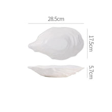 Load image into Gallery viewer, Oyster Shape Serving Dish by Allthingscurated is elegantly crafted in pristine white ceramic to mirror the contours and texture of the elegant oyster. The striking serve ware comes in multiple sizes for plating appetizers or main courses. Seen here is the 28.5cm or 11.25 inches oyster dish.
