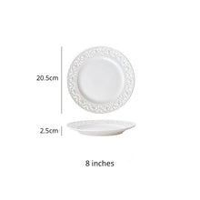 Load image into Gallery viewer, Juliette White Lace Dinnerware by Allthingscurated adds an elegant touch to your tabletop. This sophisticated set is crafted out of ceramic with a beautiful embossed lace rim, giving it a vintage touch.  The creamy white pieces come in a dinner plate and cake stand in 2 sizes for easy mixing and matching. They are perfectly sized for a main course, starters and desserts. Featured here is an 8 inches or 20.5cm plate.
