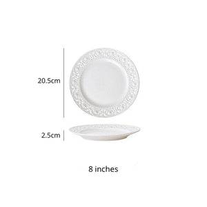 Juliette White Lace Dinnerware by Allthingscurated adds an elegant touch to your tabletop. This sophisticated set is crafted out of ceramic with a beautiful embossed lace rim, giving it a vintage touch.  The creamy white pieces come in a dinner plate and cake stand in 2 sizes for easy mixing and matching. They are perfectly sized for a main course, starters and desserts. Featured here is an 8 inches or 20.5cm plate.