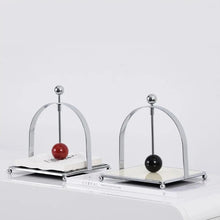 Load image into Gallery viewer, AXO Stainless Steel Paper Napkin/Serviette Holders by Allthingscurated feature a stunning range holders in a minimalist design with weighted orb in red and black, ensuring your paper napkins stay perfectly in place. Elevate your dining experience with these functional holders that are perfect for buffet tables and outdoor dining.
