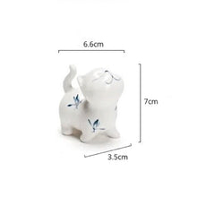 Load image into Gallery viewer, Petite Butterfly Orchid Porcelain by Allthingscurated is handmade with exquisite craftsmanship. Featuring beautiful, hand-painted blue butterfly orchids on white porcelain, the dainty design exudes an elegant charm and a touch of playfulness with its naughty and oh-so-cute expression. Small yet exquisite, it will charm any cat lovers and bring joy to any room.
