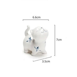 Petite Butterfly Orchid Porcelain by Allthingscurated is handmade with exquisite craftsmanship. Featuring beautiful, hand-painted blue butterfly orchids on white porcelain, the dainty design exudes an elegant charm and a touch of playfulness with its naughty and oh-so-cute expression. Small yet exquisite, it will charm any cat lovers and bring joy to any room.