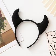 Load image into Gallery viewer, Horn Shape Headband by Allthingscurated features trendy, three-dimensional horns that is fun and perfect for elevating your Halloween party look. This accessory is perfect for adding a playful touch to your costume and make a statement at any Halloween party. Comes in 3 colors. Featured here is the black headband.
