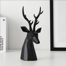 Load image into Gallery viewer, This beautiful Deer Head Bust sculpture is made of resin and comes available in 4 colors of black, white, gray and teal.  Measuring 26cm or 10 inches in height and 11.5cm or 4.5 inches in width. This figurine spots a contemporary design with sculptural form inspired by Origami. This decorative piece will add timeless elegance to your space year-round. Perfect for festive tablescapes, mantels and shelves.  This is a deer head bust in Black.
