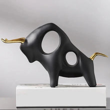 Load image into Gallery viewer, Brooklyn Bull Sculptures by Allthingscurated capture the elegance and dramatic aura of the auspicious animal in a sleek, modern design with matte black finish and gold-accented horns. A visually-appealing and timeless collection, it’s a fashionable piece to add to any contemporary home and spaces. And perfect as a gift for those with a Taurus horoscope or Chinese Ox zodiac sign. Featured here is the Charging Bull Sculpture.
