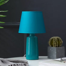 Load image into Gallery viewer, Burano Table Lamp by Allthingsucrated comes in 3 gorgeous colors in Red, Blue and Yellow.  The lamp base is made of ceramic and the lampshade of fabric.  Both the base and lampshade are of the same color.  Featured here is the blue lamp.

