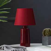 Load image into Gallery viewer, Burano Table Lamp by Allthingsucrated comes in 3 gorgeous colors in Red, Blue and Yellow.  The lamp base is made of ceramic and the lampshade of fabric.  Both the base and lampshade are of the same color.  Featured here is the red lamp.
