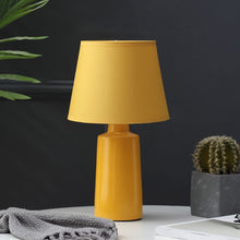 Load image into Gallery viewer, Burano Table Lamp by Allthingsucrated comes in 3 gorgeous colors in Red, Blue and Yellow.  The lamp base is made of ceramic and the lampshade of fabric.  Both the base and lampshade are of the same color.  Featured here is the yellow lamp.
