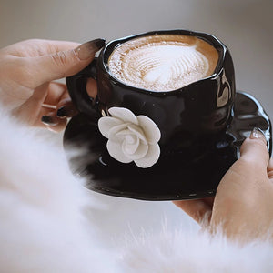 This Camellia Porcelain Cup Set / Mug by Allthingscurated features a single, significant bloom in a timeless black and white design that exudes sophistication. Its high fashion appeal makes it a perfect gift or impressive addition to your high-tea gatherings. Available as a mug or a cup set.