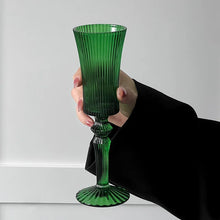 Load image into Gallery viewer, Cecily Flute Glasses by Allthingscurated feature a medieval-inspired vertical ridged design that provides a unique texture with an elegant touch. The long, sturdy stem ensures a steady hold while the jewel tones add a touch of sophistication to any celebration. Designed to complement your favorite wines, these glasses are perfect for entertaining and will brighten up any table.
