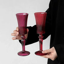 Load image into Gallery viewer, Cecily Flute Glasses by Allthingscurated feature a medieval-inspired vertical ridged design that provides a unique texture with an elegant touch. The long, sturdy stem ensures a steady hold while the jewel tones add a touch of sophistication to any celebration. Designed to complement your favorite wines, these glasses are perfect for entertaining and will brighten up any table.
