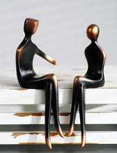 Load image into Gallery viewer, These pair of Abstract Couple Figurines has a modern and sleek design featuring a loving couple in embrace. It adds a touch of modern elegance to your space and looks sophisticated in their gradient black and bronze colors. Makes for a beautiful table tabletop decoration and perfect as a wedding or Valentine’s Day gift.
