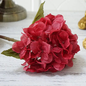 Silk Hydrangeas by Allthingscurated are made of premium quality silk that feature realistic looking flowers that are perfect for home décor and wedding venue decoration. Create a stunning display with 8 lovely colors available and add a touch of beauty and elegance to any space.  Featured here is the color Crimson Red.