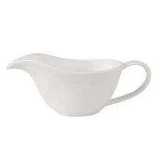 Load image into Gallery viewer, Curtis Ceramic Gravy Boat by Allthingscurated features an easy-to-hold handle and a narrow spout to ensure precise pouring without spills and drips. Available in white with a smooth, shiny glaze or black with a matte, rough finish. This versatile serveware with a capacity of 220ml or 7.4 fluid ounce is perfect for any occasion, formal or casual.  Featured here is the white gravy boat in shiny, smooth glazed finish.
