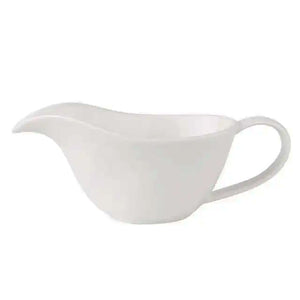 Curtis Ceramic Gravy Boat by Allthingscurated features an easy-to-hold handle and a narrow spout to ensure precise pouring without spills and drips. Available in white with a smooth, shiny glaze or black with a matte, rough finish. This versatile serveware with a capacity of 220ml or 7.4 fluid ounce is perfect for any occasion, formal or casual.  Featured here is the white gravy boat in shiny, smooth glazed finish.