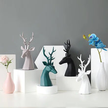 Load image into Gallery viewer, This beautiful Deer Head Bust sculpture is made of resin and comes available in 4 colors of black, white, gray and teal.  Measuring 26cm or 10 inches in height and 11.5cm or 4.5 inches in width. This figurine spots a contemporary design with sculptural form inspired by Origami. This decorative piece will add timeless elegance to your space year-round. Perfect for festive tablescapes, mantels and shelves. 
