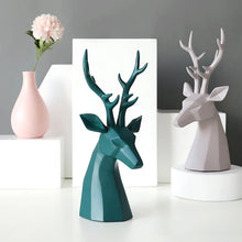 Load image into Gallery viewer, This beautiful Deer Head Bust sculpture is made of resin and comes available in 4 colors of black, white, gray and teal.  Measuring 26cm or 10 inches in height and 11.5cm or 4.5 inches in width. This figurine spots a contemporary design with sculptural form inspired by Origami. This decorative piece will add timeless elegance to your space year-round. Perfect for festive tablescapes, mantels and shelves.
