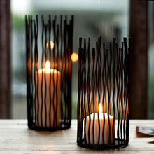 Load image into Gallery viewer, Estel Black Wire Candle Holders by Allthingscurated have openwork pattern that resembles willow-like branches in a cylindrical arrangement.  Crafted from iron and in black finish, these candle holders come in 3 sizes.
